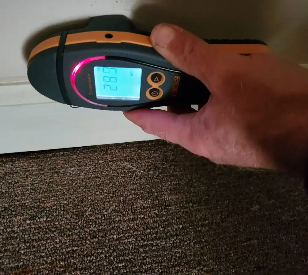 Moisture detection at baseboard during Storm Damage Restoration in East Point